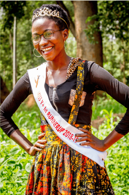 Miss Young Positive First Runner Up 2018/19 Sharon Amongi poses outside of the ART adolescent clinic at Lira Re-gional Referral Hospital in her sash and crown. 