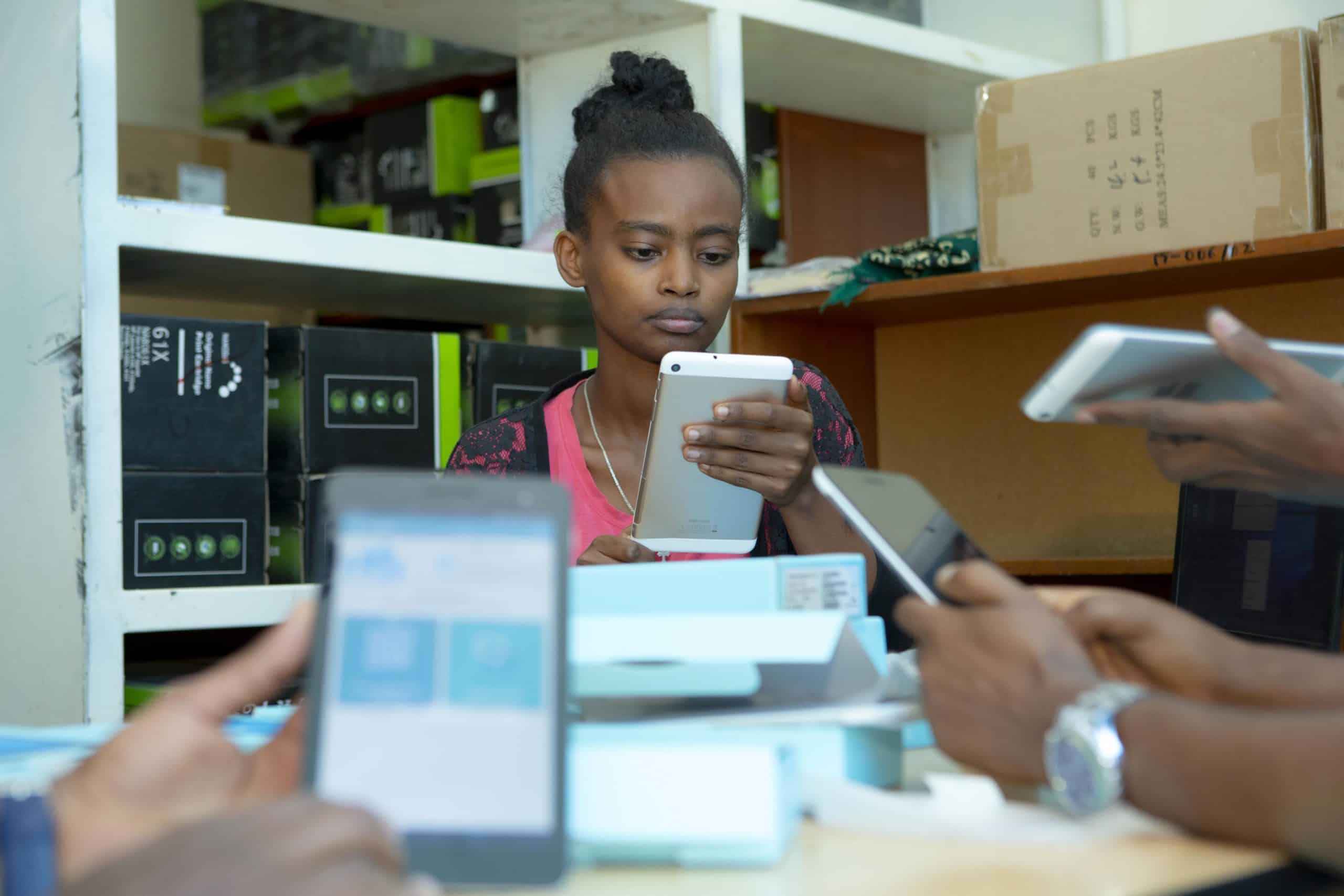 Ethiopia Data Use Partnership Intern working on her phone