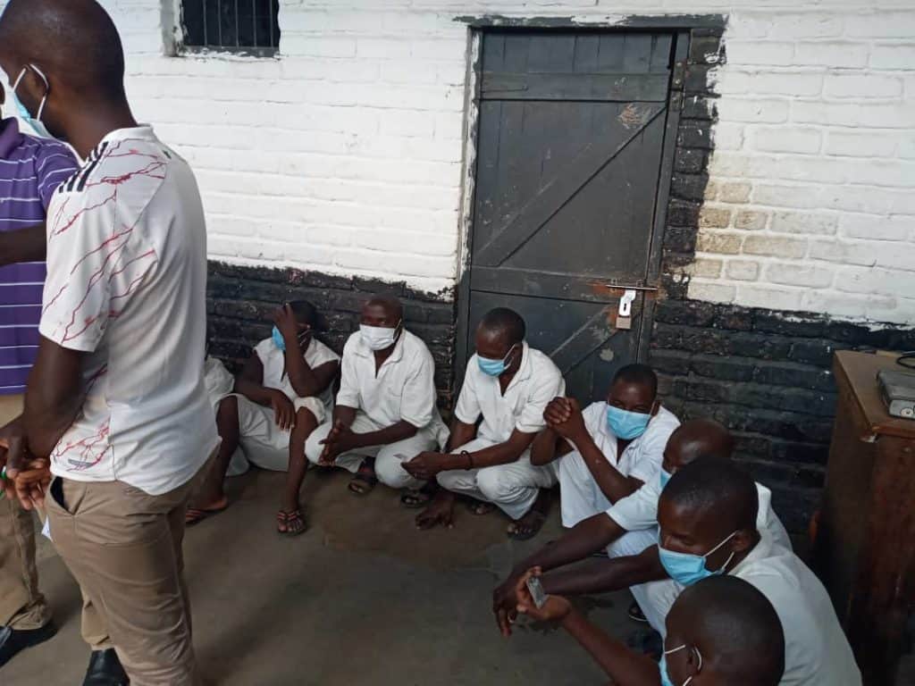 Prisoners in malawi wait to receive the covid vaccine
