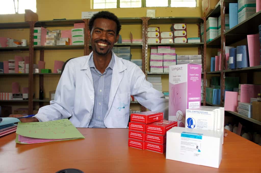 A pharmacy worker in Ethiopia smiles for a photo.