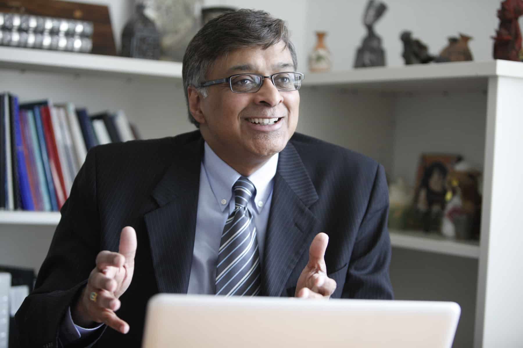 Dr. Nandakumar sits at his desk