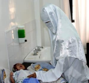 A Yemeni doctor examines a baby