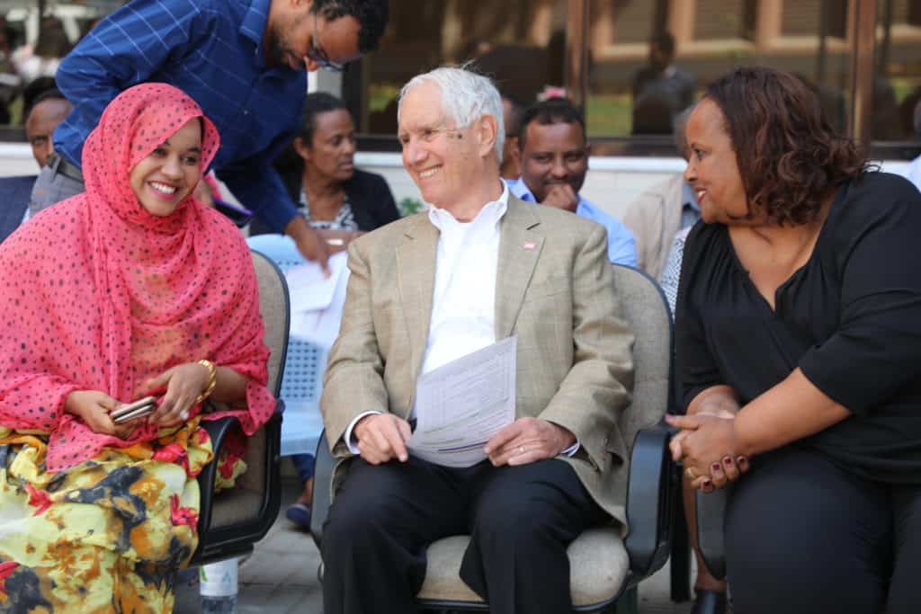Joel sis with two JSI staff members at the 25th anniversary of JSI's presence in Ethiopia.