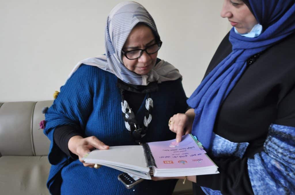 Dr. Madiha reviews family planning guidelines with a colleague.