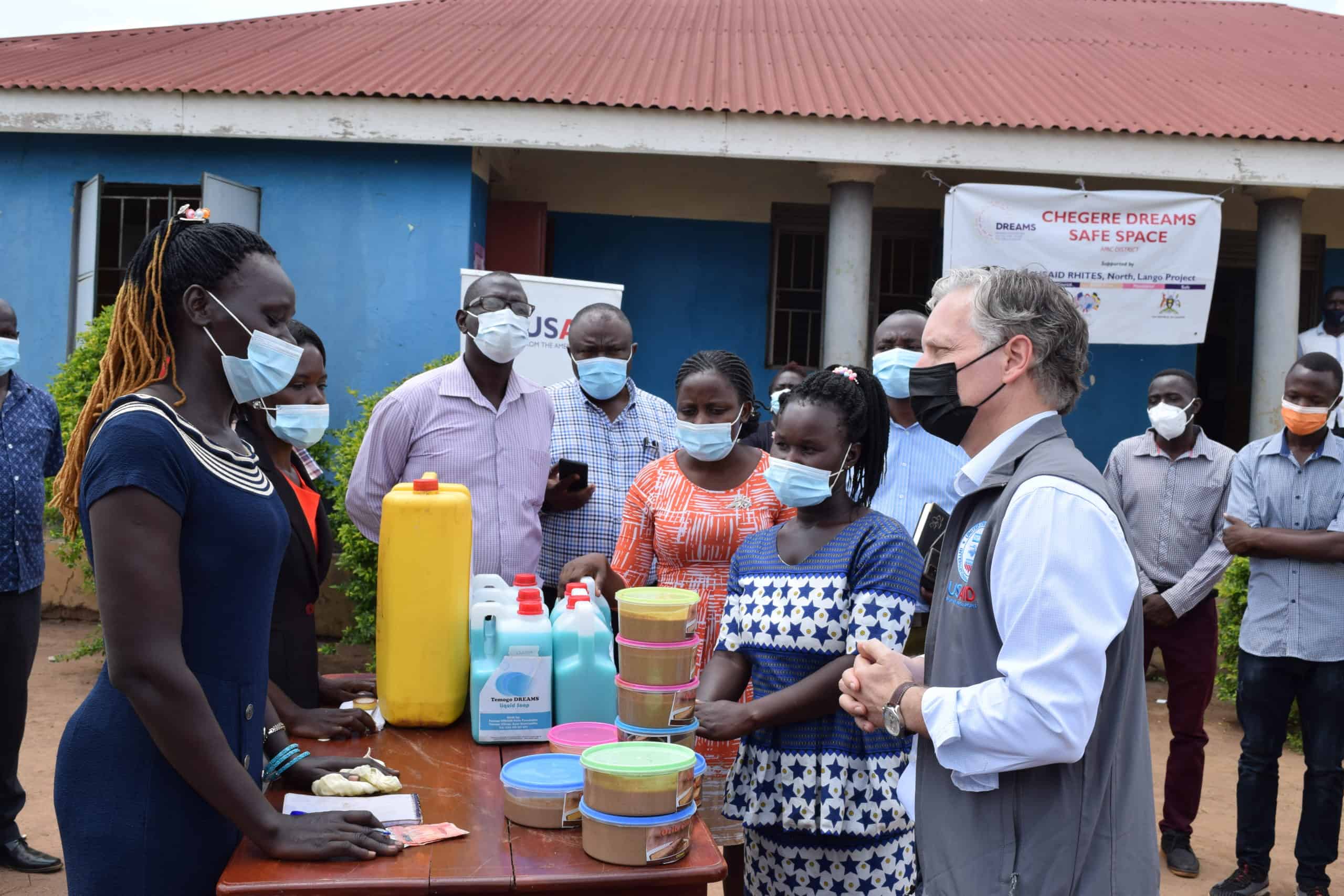 USAID Uganda Mission Director Richard Nelson interacts with DREAMS girls who were supported with income generating activity startup kits by USAID RHITES-N, Lango Activity.