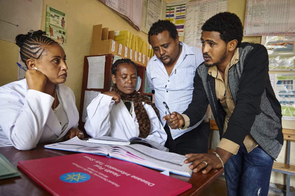 While Tesfu Negasa (right), Zonal HMIS Office, discusses Tally Sheet and it's importance to HMIS with health team members at a Chancho Buba Health Post in Oromia Region. Ethiopia.