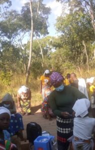 health staff administers the covid-19 vaccine to a religious group in Zambia