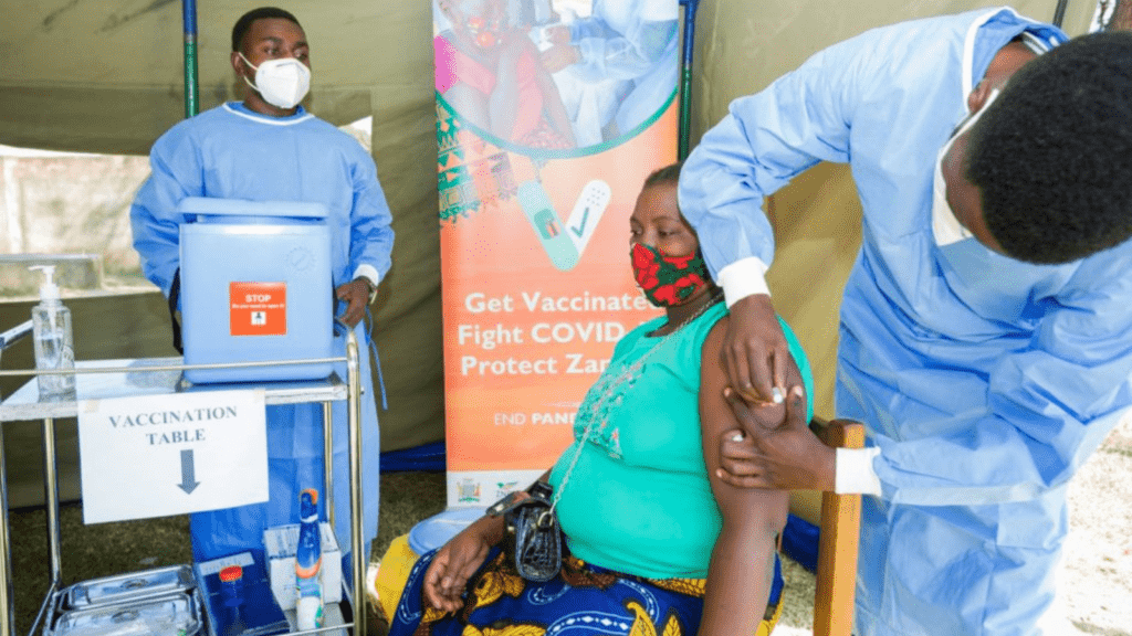 A Zambian woman getting a COVID-19 vaccine