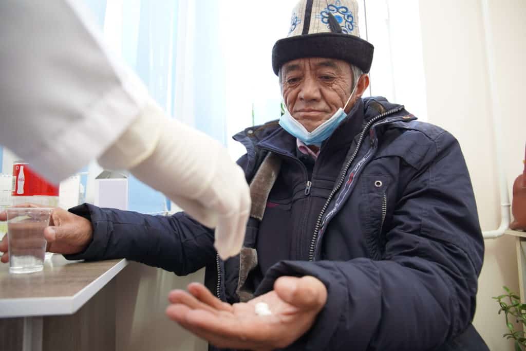 Ishen Koldoev, a TB patient, takes his medicine.