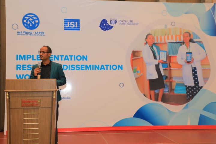 Man standing at podium for JSI presentation