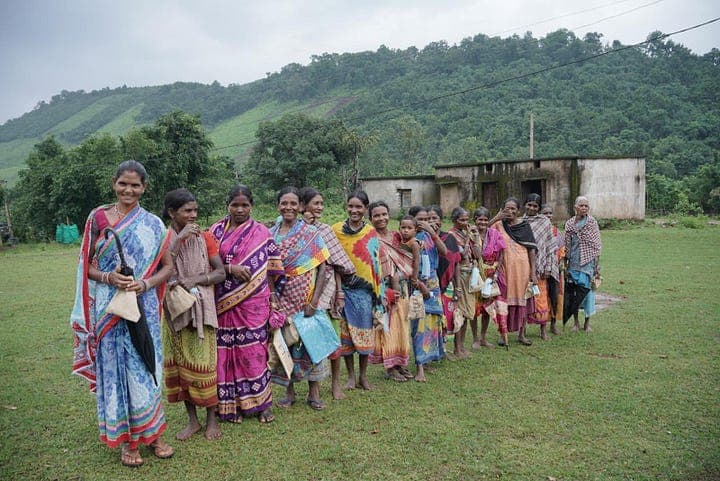 Women from the Kondh tribe in Odisha, India, pose for a photo after receiving their COVID-19 vaccination
