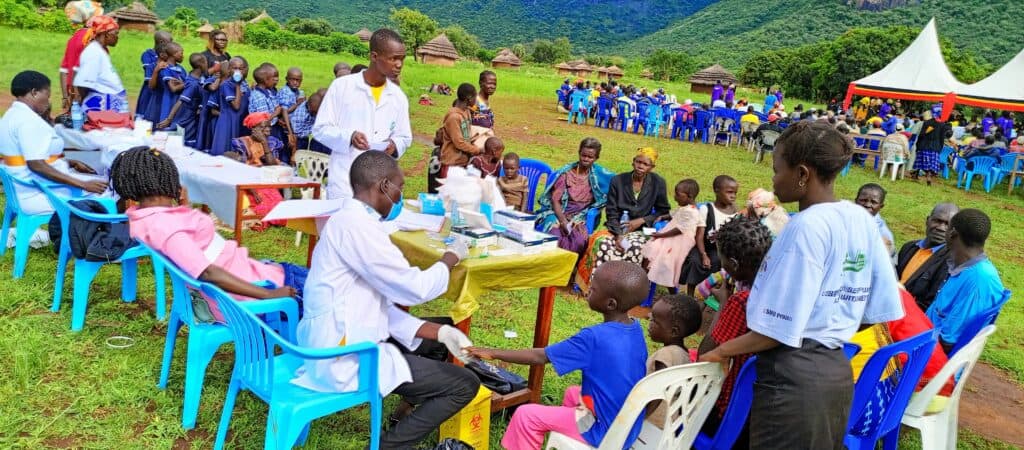 Villagers gather for malaria testing and treatment in Uganda