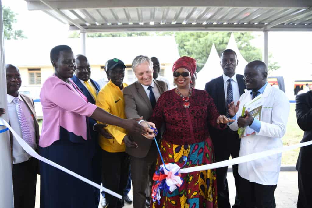 People gather around for a ribbon cutting event in Uganda for the Orum Health Center IV