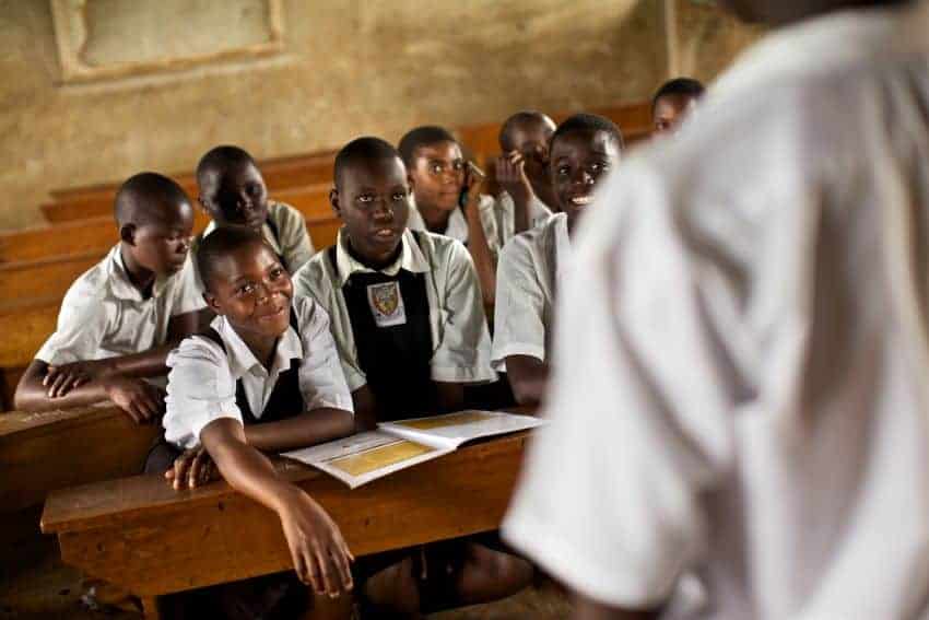 Students sit at desks in an African classroom