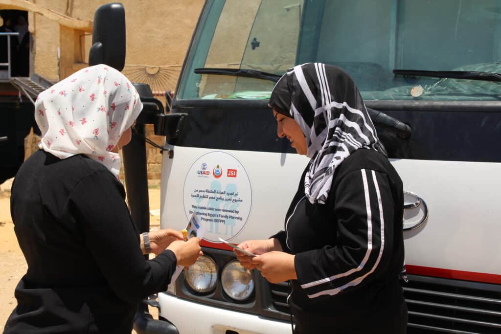 Egyptian peer educator providing information on family planning at a mobile clinic to a client.