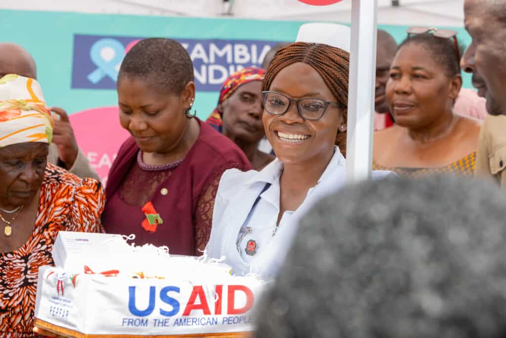Dorcas, a nurse at the Mwanjuni Health Post, accepts the first box of long-acting cabotegravir (CAB-LA) as she prepares to administer the first dose in Zambia.